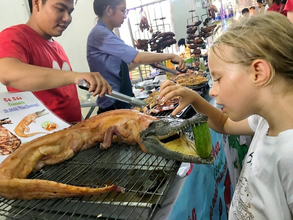 Zozo and "skinless" crocodile the travelling twins eat in southeast Asia street vendors