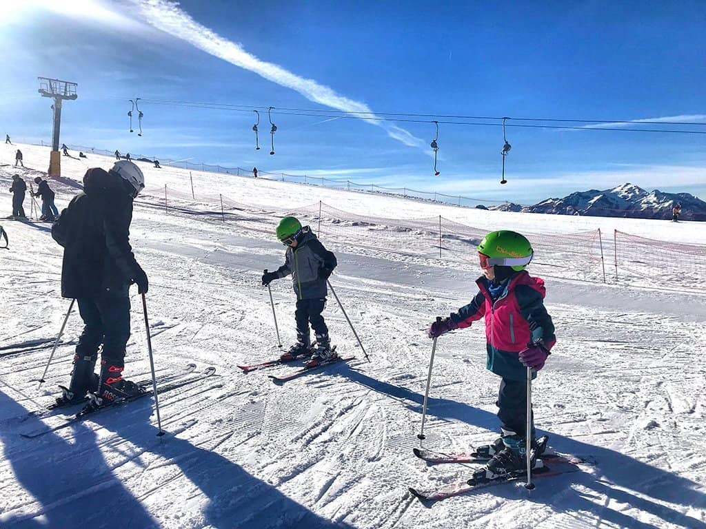 Children ski lesson on nursery slope in Tognola, San Martino di Castrazzo