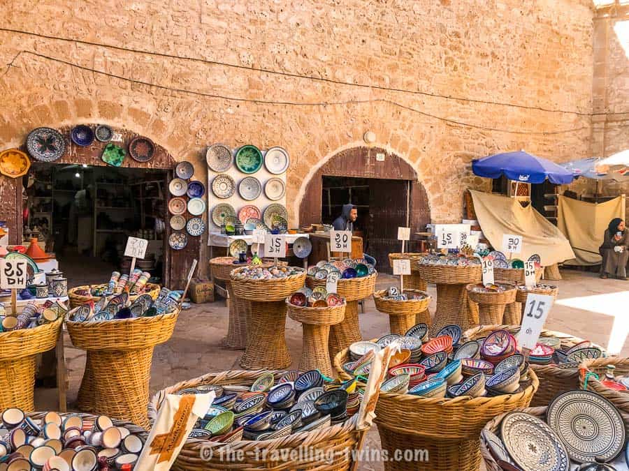 various design ceramic plates, tajine display in baskets on market in Essaouira 