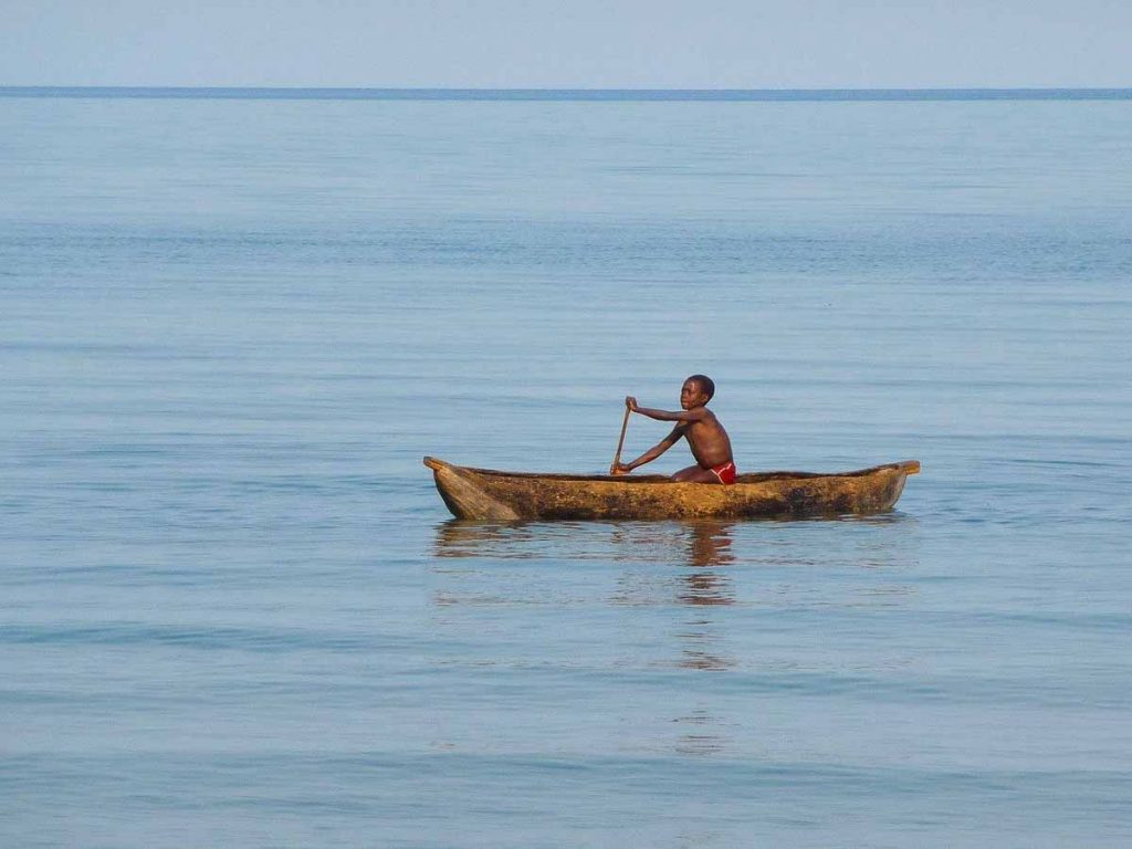 boy in a canoe on lake Malawi