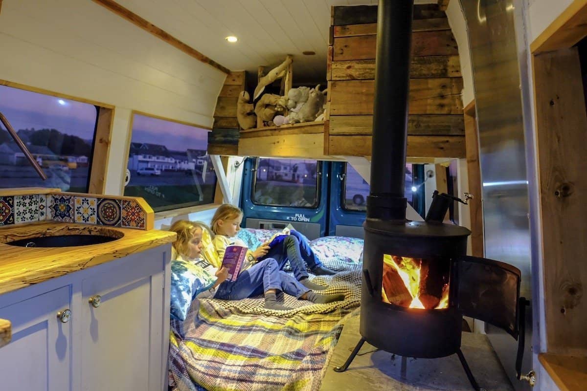 woodburner inside campervan, camping in october