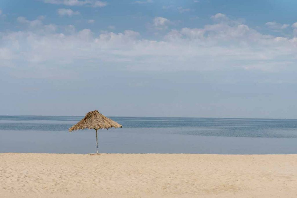 beach and umbrella on the shore of Lake Tanganyika
